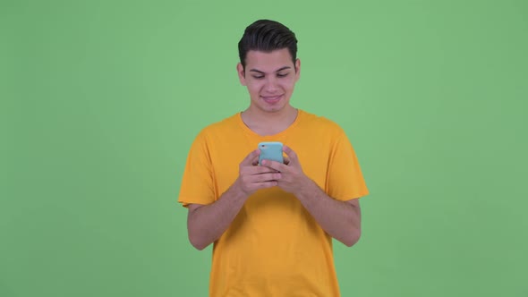 Happy Young Multi Ethnic Man Thinking While Using Phone