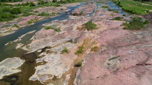 Aerial footage of the popular area on the Llano River in Texas called The Slab.  Camera is moving fa