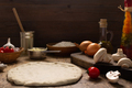 Pizza homemade cooking with ingredients on table. Dough pizza on tabletop - PhotoDune Item for Sale
