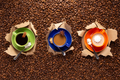 Cup of coffee and beans in torn paper. Coffee espresso on bean background - PhotoDune Item for Sale