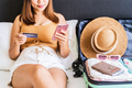 Young woman using smart phone booking a hotel online with a credit card - PhotoDune Item for Sale