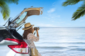 Young woman traveler taking a photo at the beach with car on roadtrip, Summer vacation - PhotoDune Item for Sale