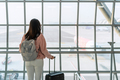 Young woman traveler looking at the airplane at the airport, Travel concept - PhotoDune Item for Sale