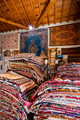 Large stacks of oriental  rugs in a store. Colorful carpet market. Turkey - PhotoDune Item for Sale