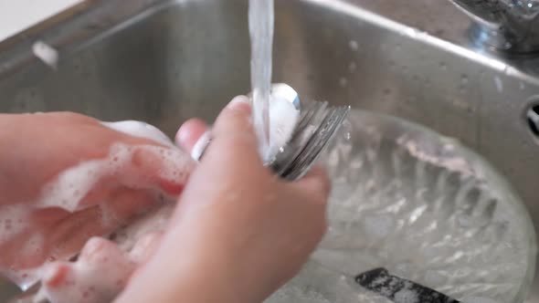 Woman Washes the Dishes By Hands, Hands Closeup.