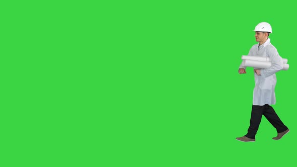 Engineer Holding a Blueprint for His Work Walking By on a Green Screen, Chroma Key alt
