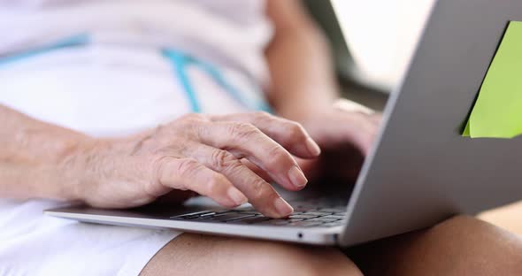 Elderly Woman Typing on Laptop Keyboard Closeup  Movie