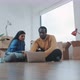 Couple in their new flat sitting on the floor shopping online - VideoHive Item for Sale