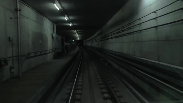 Cabin View of Train Moving in Dark Subway Tunnel