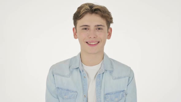 Young Man Smiling at Camera on White Background