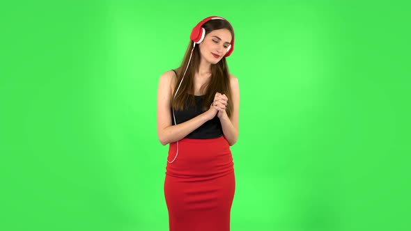 Cheerful Girl Dancing and Enjoys Music in Big Red Headphones