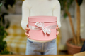 Female hands holding, give pink gift with white ribbon, present box, - PhotoDune Item for Sale