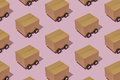Cardboard boxes on wheels like trucks carry parcels and make deliveries. - PhotoDune Item for Sale