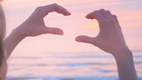 Hands As Heart Shape with Pastel Sunset
