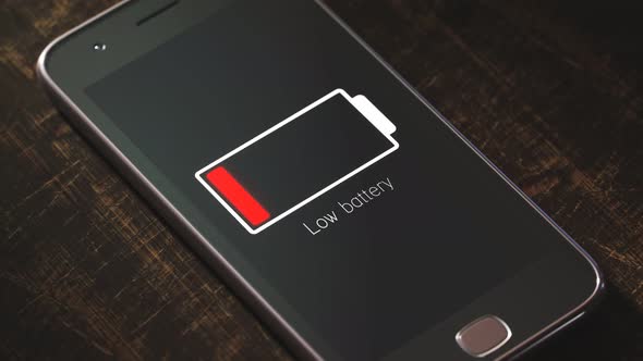 Generic smartphone with flashing low battery symbol. The battery is exhausted.