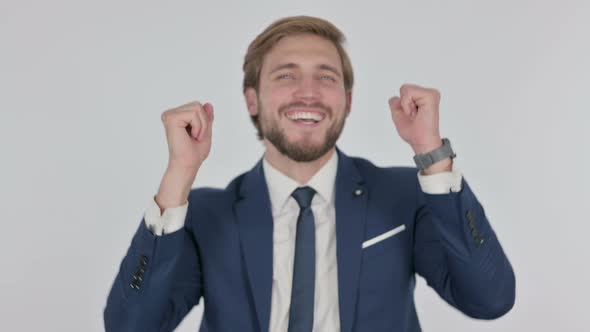 Young Businessman Dancing in Joy on White Background