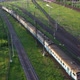 Train with wagons rides on rails - Aerial drone shot over railway. - VideoHive Item for Sale