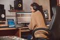 Woman blogger records online podcast using laptop, headphones and microphone in music studio - PhotoDune Item for Sale
