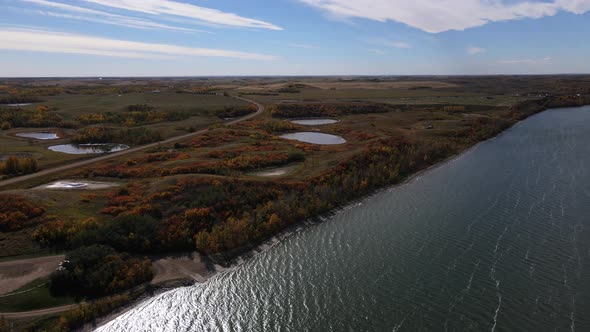 Descending aerial footage in 4k over Buffalo lake in Canada during fall 2021. Magnificent Autumn fol