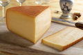 Piece of Dutch Kernhem cheese and a slice on a cutting board - PhotoDune Item for Sale