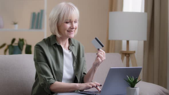 Elderly Caucasian 60s Woman Internet Shopping on Laptop at Home