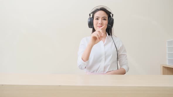 young attractive asian female office woman operator wear headphone