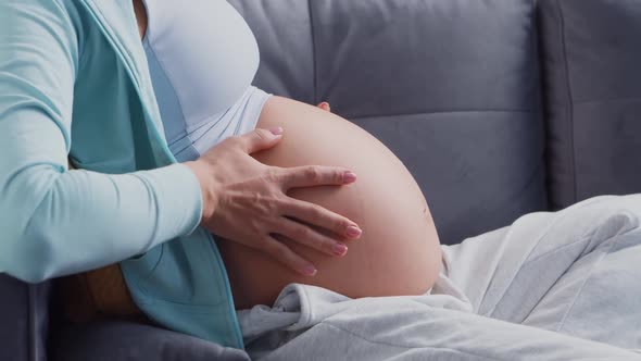 Young pregnant woman is resting at home and expecting a baby.