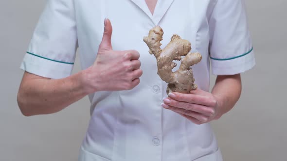 Nutritionist Doctor Healthy Lifestyle Concept - Holding Ginger Root and Medicine or Vitamine Pill