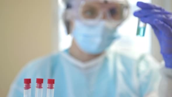 An Expert Works on a Covid 19 Coronavirus Vaccine in a Clean Laboratory with a Protective Suit