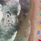 Picturesque summer beach with shipwreck and colourful umbrellas, aerial drone top down view 4k - VideoHive Item for Sale