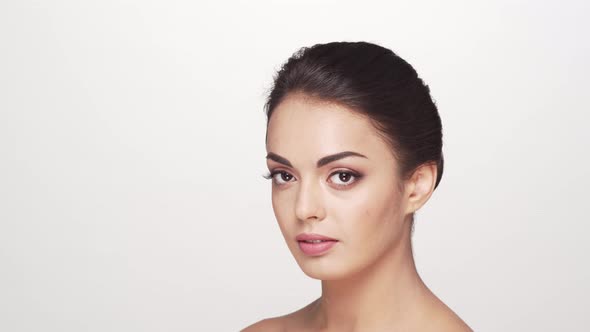 Studio portrait of young and beautiful brunette woman over