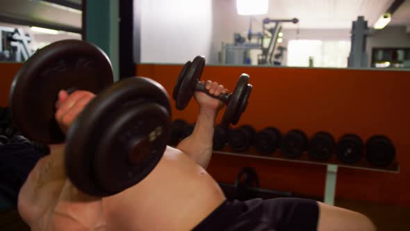 Man lifting heavy dumbbells