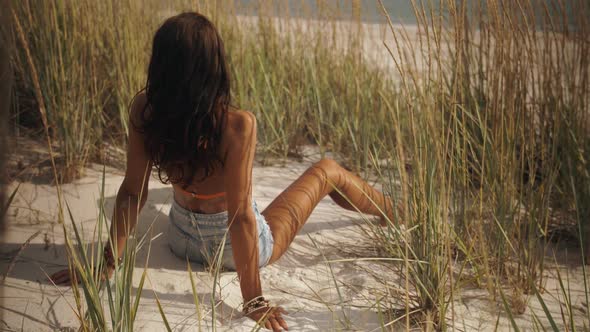 Boho Woman on the Beach Near the Sea