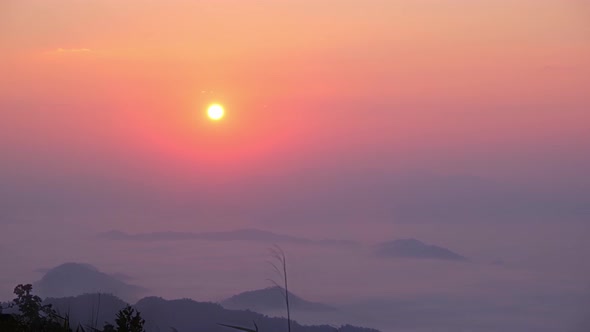 4K : Timelapse of colorful sunrise over the heavy fog in the during morning