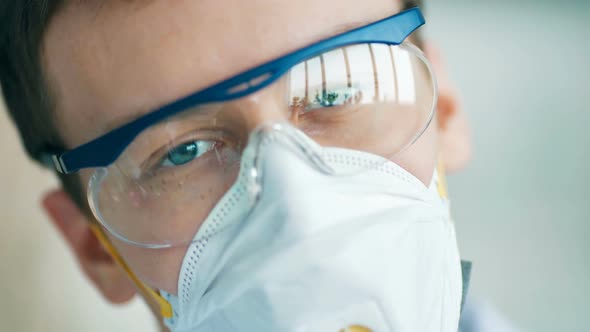 Young Scientist in Protective Glasses and Mask Looking to the Camera