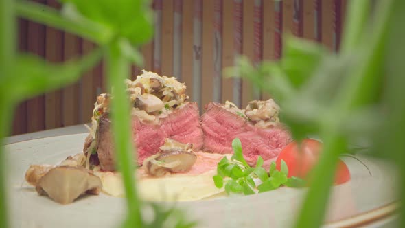 Zoom Out Video of Filet Mignon Steak Cut in Halves Microgreen Pea Sprouts