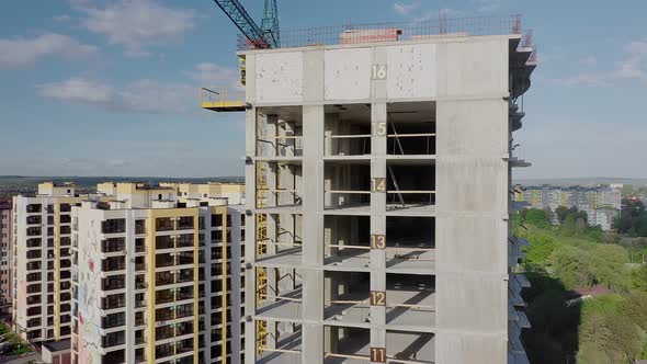 Aerial view of high residential apartment building under construction. Real estate development.