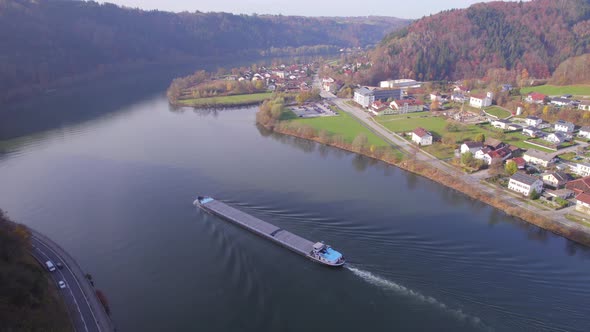 Cargo Pusher Boat on a River Transporting Cargo and Goods Along a River Bend