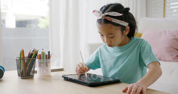 at touch screen use stylus pen design idea coloring art on home school online class app. Smart kid happy leisure indoor activity sit at table sofa.