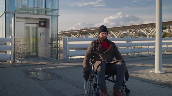 Man with Physical Disability and Paraplegia is Moving By Wheelchair in City