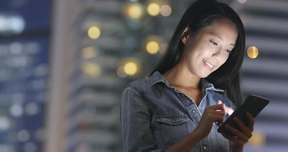 Businesswoman use cellphone at night