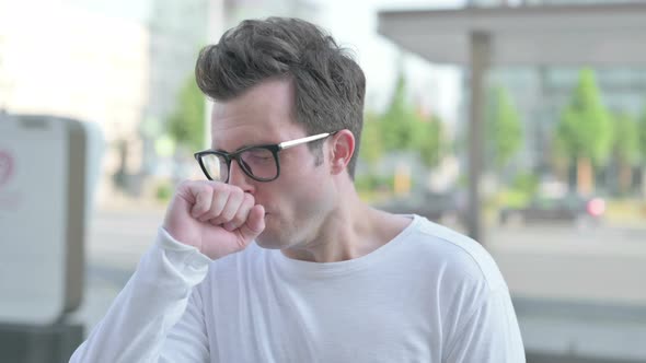 Young Man Coughing While Standing Outdoor
