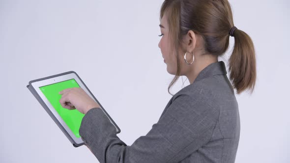 Closeup Rear View of Young Happy Asian Businesswoman Using Digital Tablet