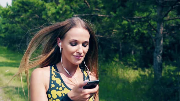 CU Portrait Young Girl Goes in for Sports in the Morning Runs Along a Pine Forest She Has Wristlets