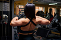Sports woman in the gym shows the muscles - PhotoDune Item for Sale
