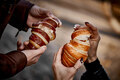 Close-up of couple's hands with croissant - PhotoDune Item for Sale