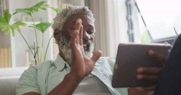 Video of african american senior man using tablet