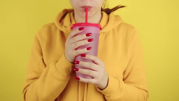 Body Part of Woman with Red Manicure Holding Large Cup