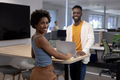 Portrait of smiling african american colleagues with laptop on desk working together in office - PhotoDune Item for Sale