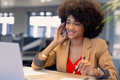 Smiling young african american female advisor talking on headset while working at modern workplace - PhotoDune Item for Sale
